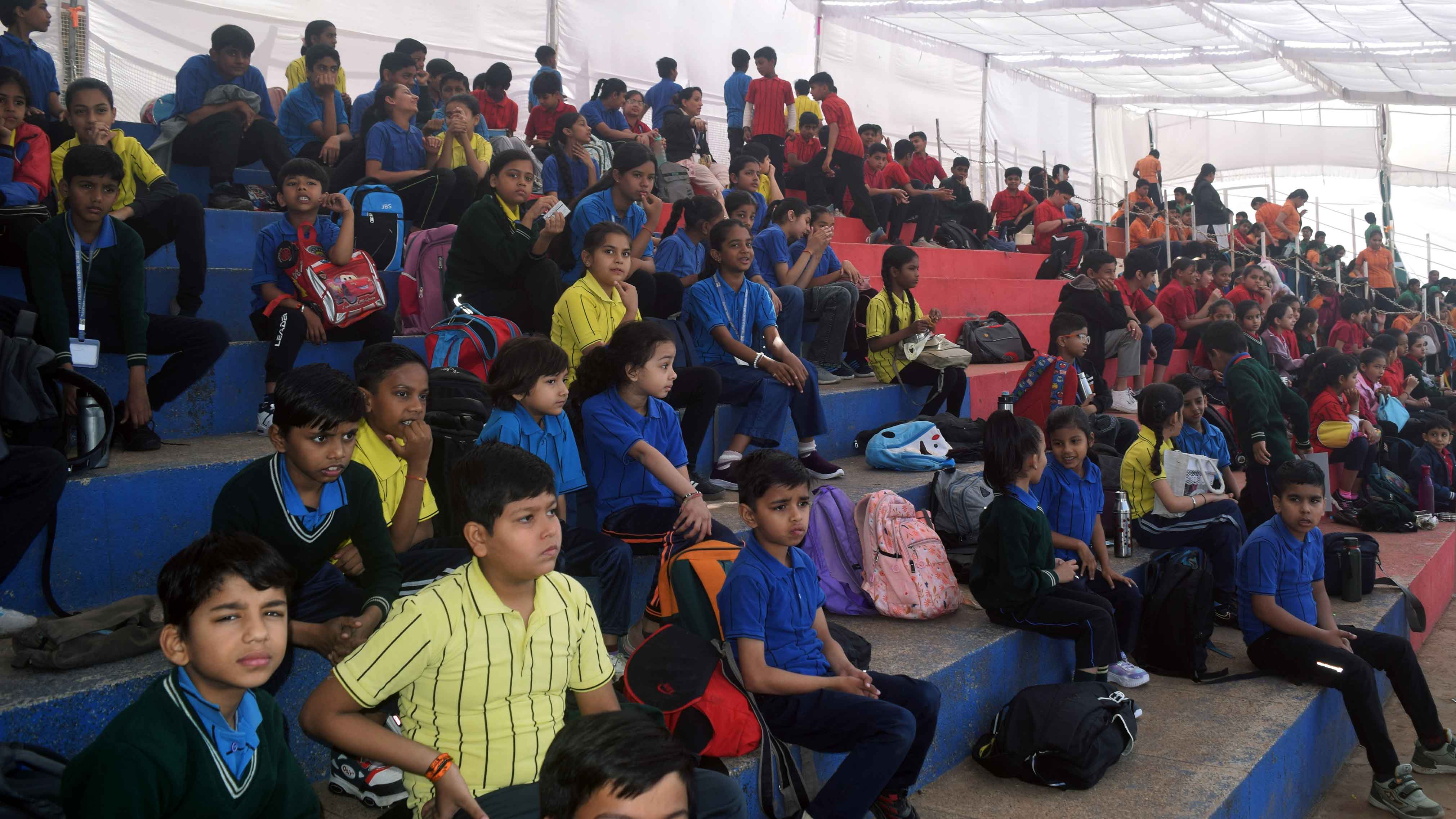 Students running track events at school sports day